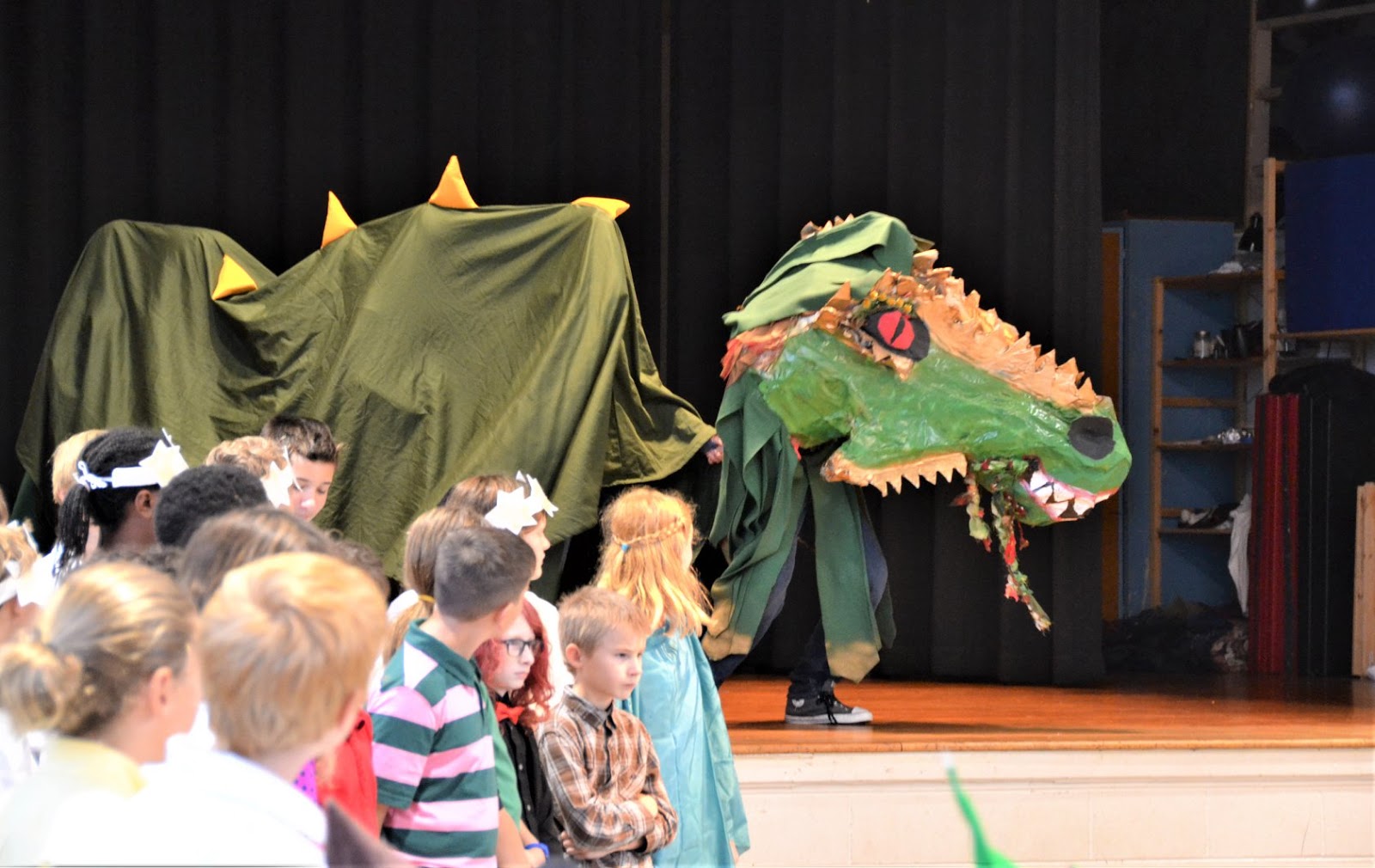A traditional pageant performed by Grades students depicts the story of Saint Michael and the Dragon